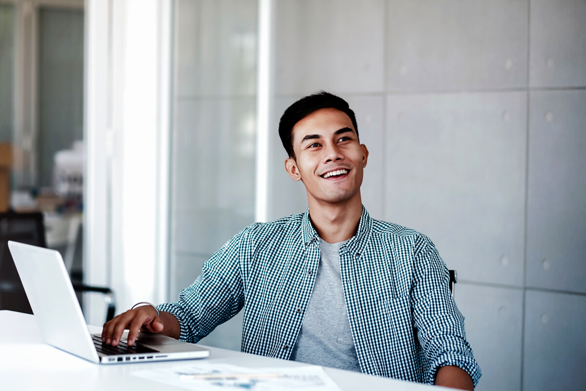 Happy Employee Working on His Laptop    